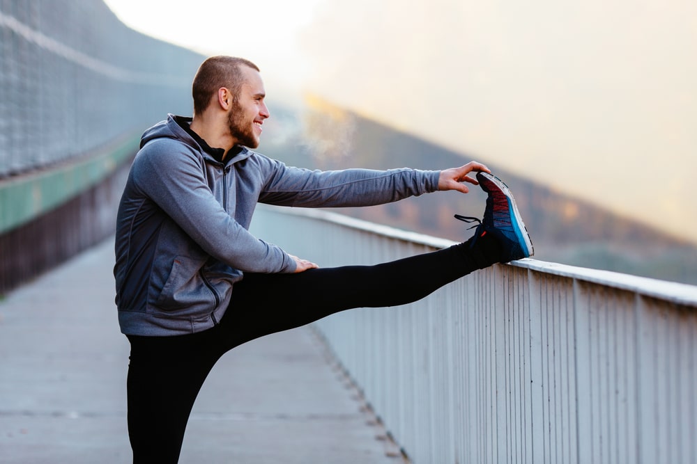 Athletic,Runner,Doing,Stretching,Exercise,,Preparing,For,Morning,Workout,In
