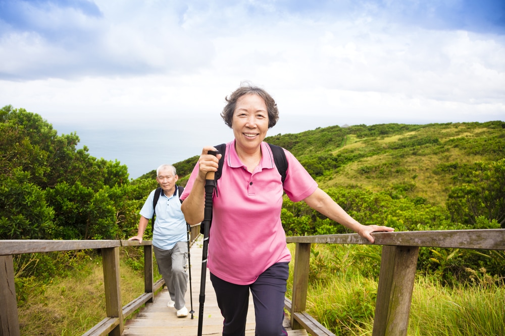Happy,Senior,Couple,Hiking,On,The,Mountain
