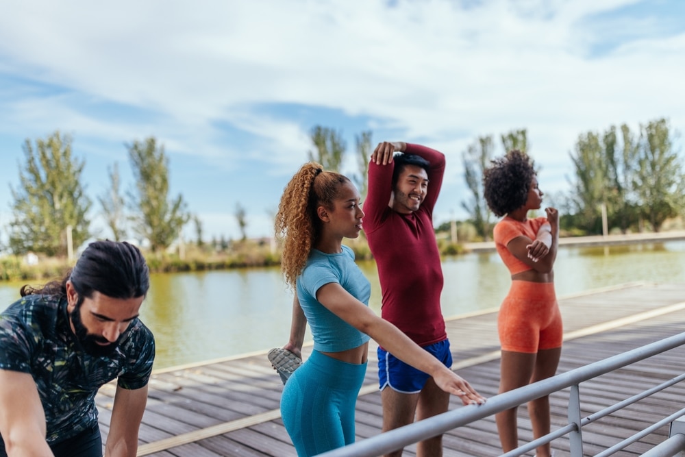 Diverse,Group,Of,Sportspeople,Stretching,Before,Training,During,The,Day