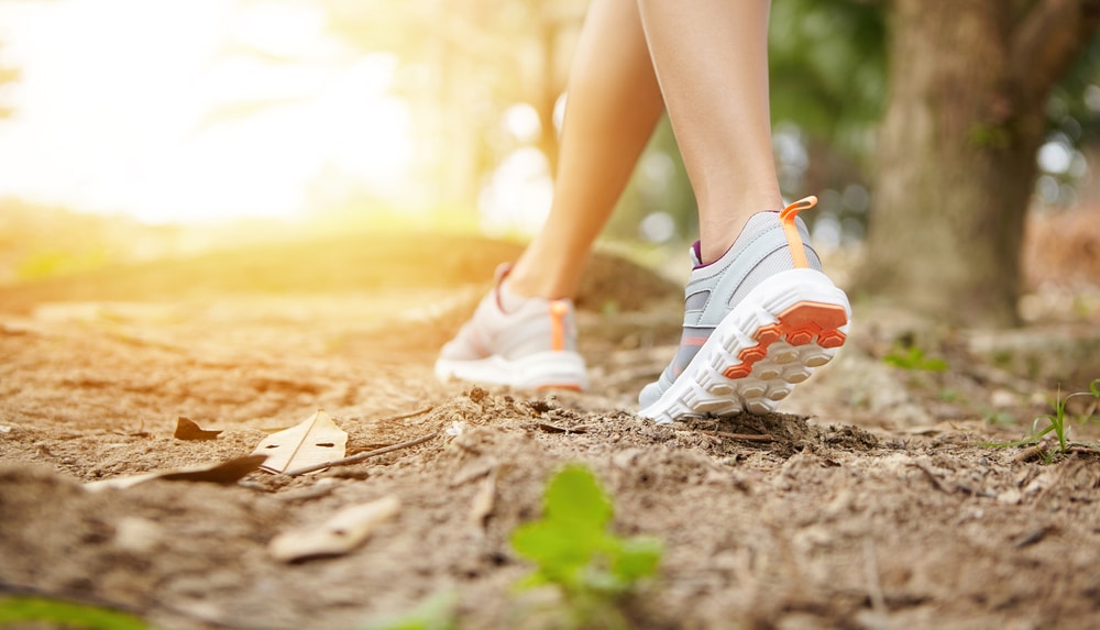 Woman,Runner,In,Sneakers,During,Run,On,Trail,In,Forest.