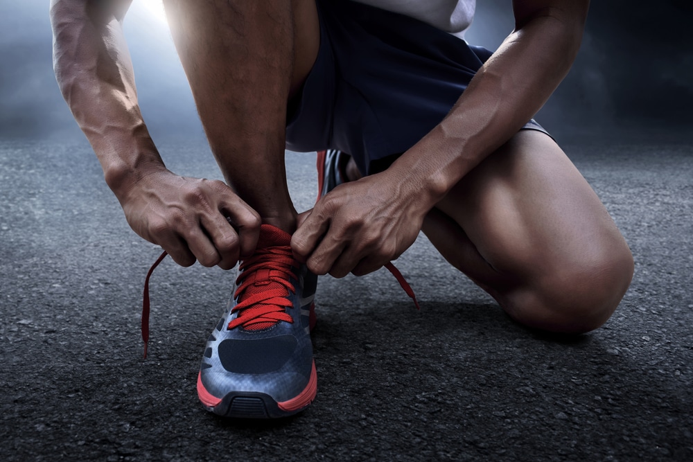 Man,Tying,Running,Shoes